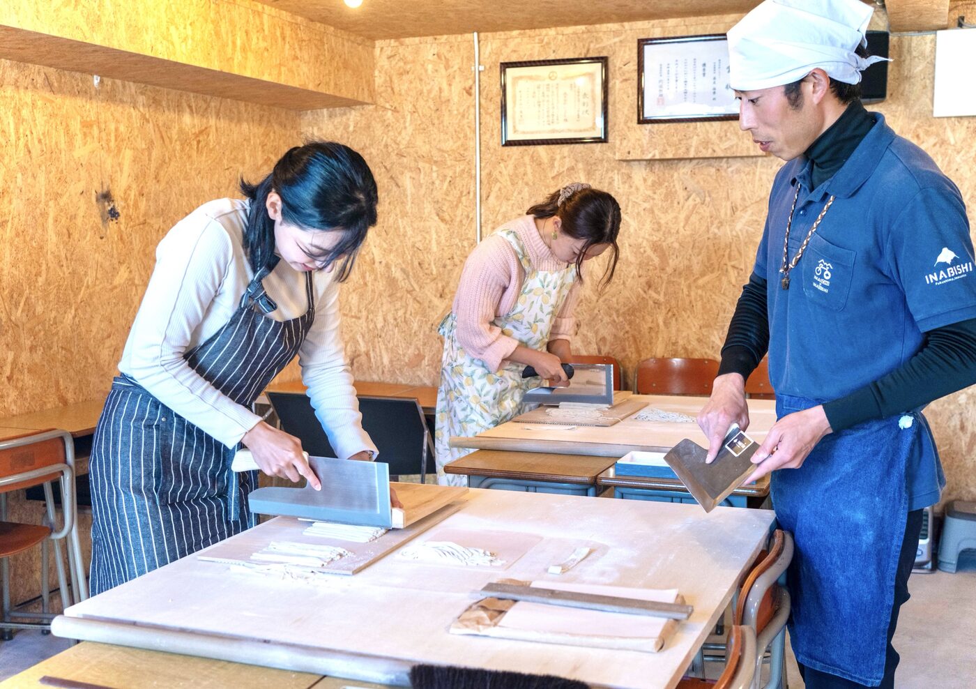そば職人に教わりながら、そばを切る体験の様子